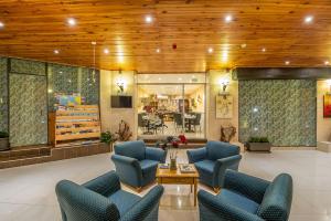 a lobby with blue chairs and a table at Alborada Apart Hotel in Sliema