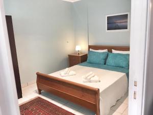 a bedroom with a bed with two towels on it at Renovated apt 100m from beach WiFi AC in Anavyssos