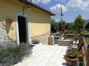 a building with a door and some plants and flowers at Locanda Tre Frati in Pescocostanzo