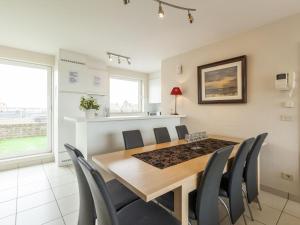 a dining room with a table and chairs at Penthouse with 2 terraces and sea casino views in Middelkerke