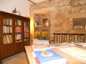 sala de estar con mesa y pared de ladrillo en Agriturismo Il Palmarone, en Rotella