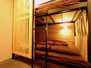 a bunk bed room with a couple of bunk beds at Namba Guesthouse HIVE in Osaka