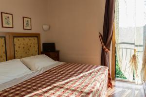 Posteľ alebo postele v izbe v ubytovaní Hotel Il Giardino