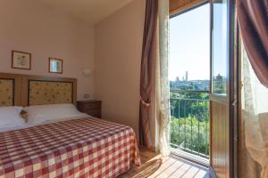Posteľ alebo postele v izbe v ubytovaní Hotel Il Giardino