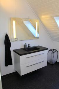 a bathroom with a sink and a mirror at Nordic Inn Thorshavn in Tórshavn