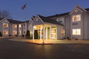 a large building with lights in front of it at Microtel Inn by Wyndham - Albany Airport in Latham