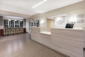 a lobby of a mco hotel with a waiting area at Microtel Inn & Suites by Wyndham Perry in Perry +25 photos