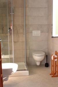 a bathroom with a shower and a toilet and a sink at Casa Laura in Imperia +22 photos