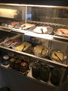 a display case with many different types of food at Norrgården i Sandviken in Sandviken