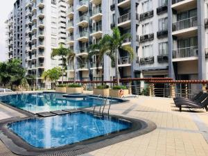 a swimming pool in front of a large apartment building at 3N Palm Tree Villas in Manila