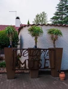 a fence with potted plants on it next to a wall at Muse On Griessel in Boksburg