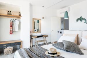 a bedroom with a bed with a hat on it at NiMar Villas in Plaka