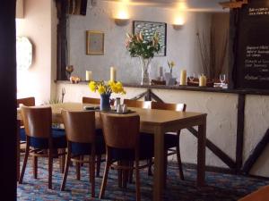 a dining room table and chairs with flowers on it at Glamping on the Hill in Mells