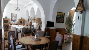 a dining room with a table and chairs and a tv at Parasolka in Odesa