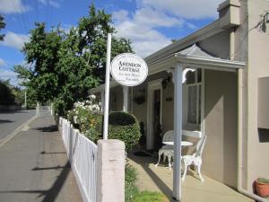 a sign on the side of a house with a table at Arendon Cottage in Evandale