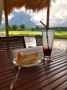 a plate with a sandwich and a drink on a table at Baan Porhdoi Goidao in Chiang Dao