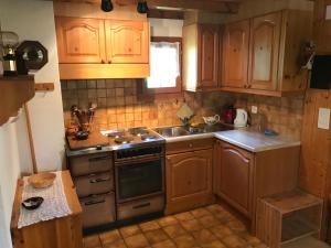 a kitchen with wooden cabinets and a sink and a stove at Rehli in Blatten bei Naters