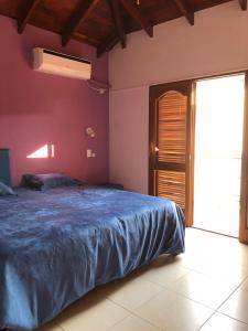 a bedroom with a bed with a blue blanket on it at La casona de ensueño in Formosa