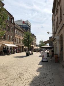 a cobblestone street in a city with buildings at Downtown City - PrivateRooms in Fürth