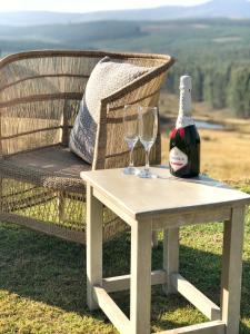 a table with two glasses and a bottle of wine at Curry's Post Bed & Breakfast in Curryʼs Post +93 photos