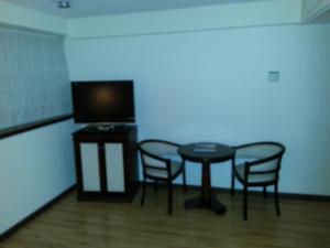 Uma TV ou centro de entretenimento em Villaggio Hotel Boutique