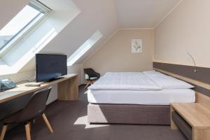 Posteľ alebo postele v izbe v ubytovaní Hotel Panská Zahrada