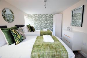 a bedroom with two beds and a mirror at The Old Bank - Your Apartment in Bristol