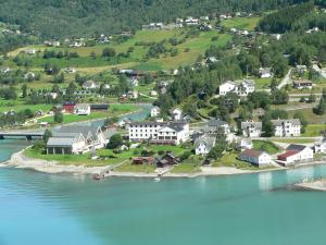 an aerial view of a town on the shore of a lake at Skjolden Hotel in Skjolden +30 photos