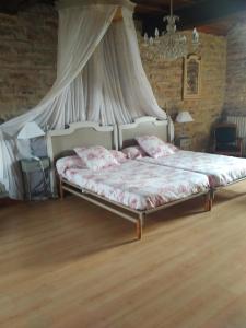 a bedroom with a bed with a canopy at Auberge de La Halle in Cordes-sur-Ciel