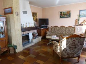 a living room with a couch and a fireplace at Chambres d'Hôtes La Plantade in La Barthe-de-Neste