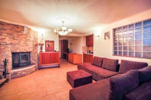 a living room with a couch and a fireplace at Apartments Risteski in Ljubaništa