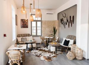 a living room with a table and chairs at Kumba in Chania