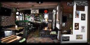 a restaurant with wooden tables and chairs and a bar at Pension Kokett in Cîmpulung +32 photos