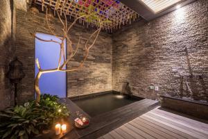 ein Zimmer mit einem Pool in einer Backsteinwand in der Unterkunft Mulan Motel in Taichung