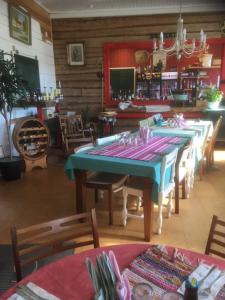 a dining room with a blue table and chairs at Kansakoulu in Västanfjärd