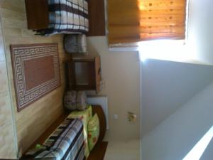 a small room with a refrigerator and a window at Pallada Motel in Pasiky-Zubryts'ki