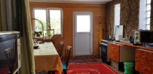 a kitchen with a table and a stove and a door at Kincsesbánya in Kincsesbanya