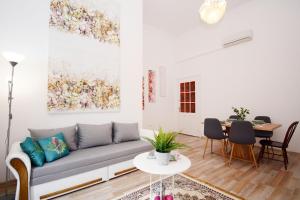 a living room with a couch and a table at Lillybeth City Center Apartments in Budapest