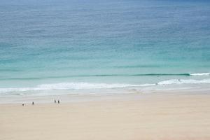 a group of people walking on the beach at Durness Youth Hostel in Durness