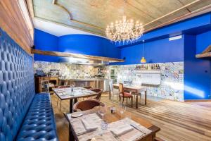 a restaurant with blue walls and tables and chairs at Aux Pieds du Roi - Suite & Spa in Breuil-Cervinia