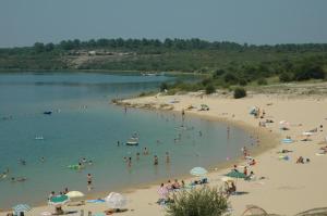 a group of people on a beach in the water at l'Airial de Nahouns in Sabres +8 photos