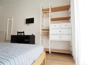 A bed or beds in a room at Bella Vita Rooms