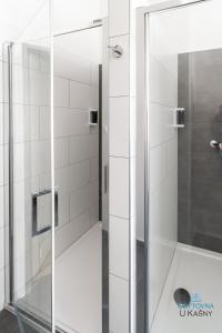 a shower with a glass door in a bathroom at Ubytovna U Kašny in Uherské Hradiště