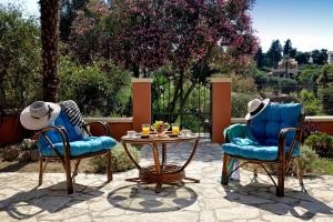 two chairs and a table on a patio at Alessandro's Apartment in Mantoúkion