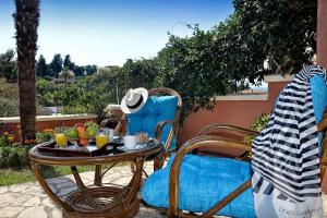a table and chairs on a patio with drinks on it at Alessandro's Apartment in Mantoúkion