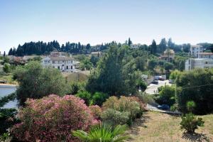 a view of a city with trees and flowers at Alessandro's Apartment in Mantoúkion +7 photos