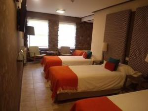 Postel nebo postele na pokoji v ubytování Hotel ACA El Calafate