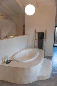 a large bathroom with a large tub in a room at Unembeza Boutique Lodge & Spa in Hoedspruit