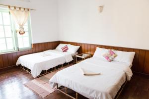 Postel nebo postele na pokoji v ubytování Ananda Tree House Eco Homestay