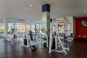 a gym with several tread machines in a room at Marina Fiesta Resort & Spa, A La Carte All Inclusive Optional in Cabo San Lucas